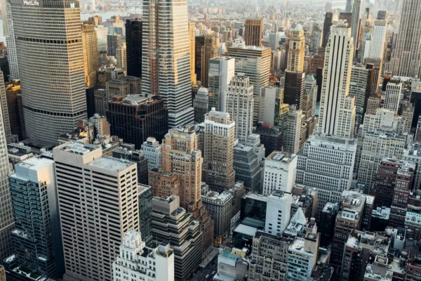 Aerial view of densely packed skyscrapers and buildings in a city during daylight.
